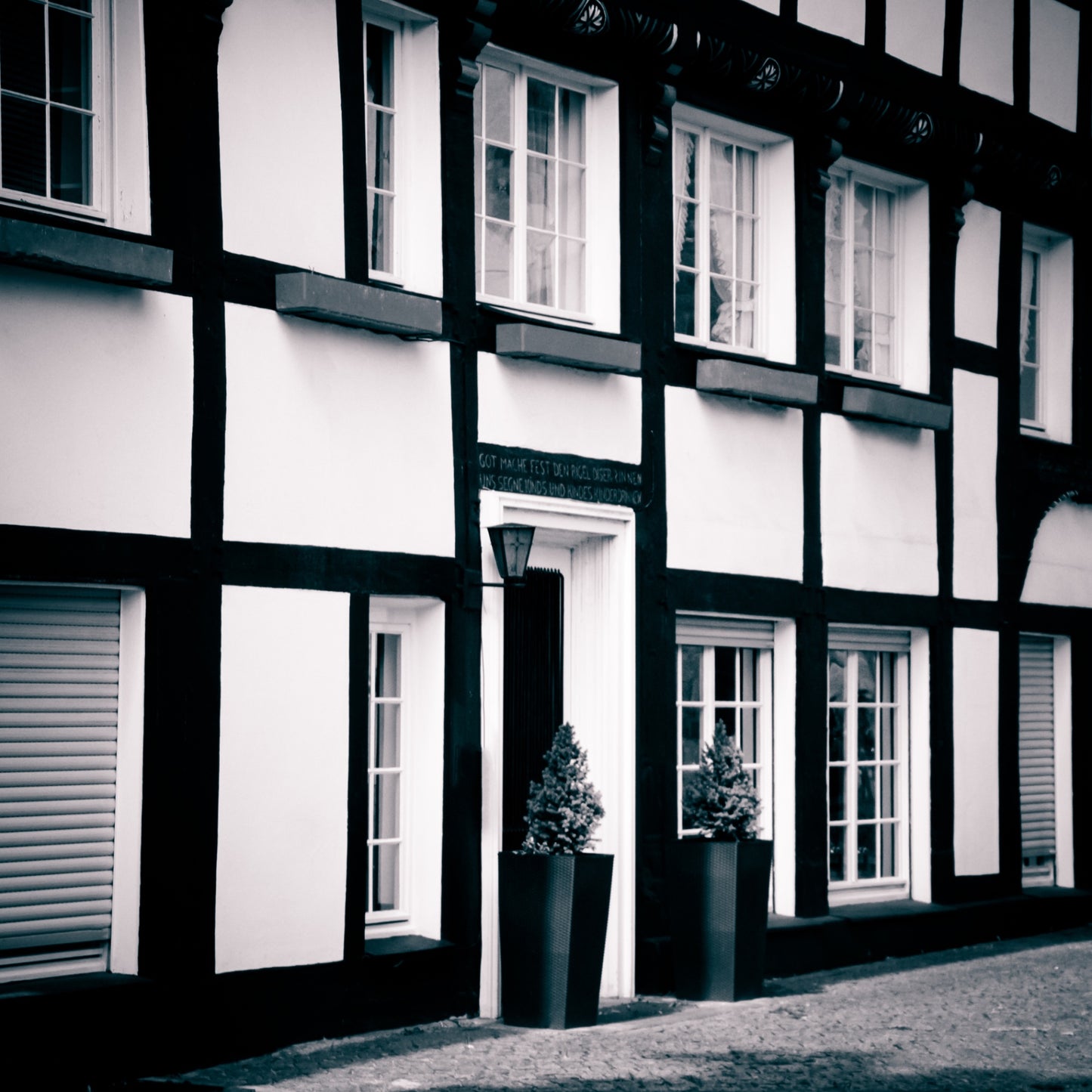 Schwarz-weißes Fachwerkhaus in ruhiger Straßenansicht